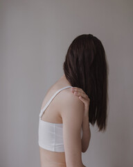 woman's back in white top with black hair