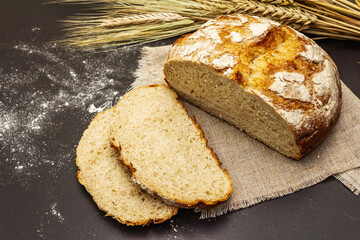 Fresh baked bread with wheat ears and linen napkin