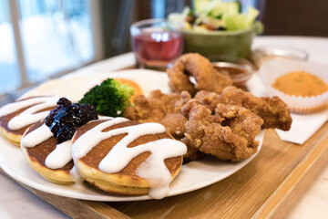 Classic USA breakfast. fried chicken, pancakes waffles, fried eggs.