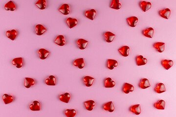 Valentine's day background of red hearts on pink backdrop. Holiday, father and mother day, background and postcard