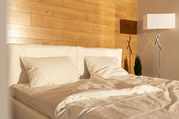 interior photo of a cozy room with a big bed where is comfortable and beautiful white bedding