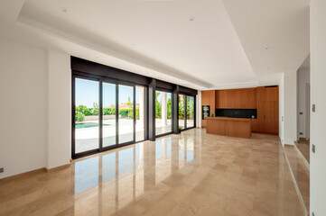 Large unfurnished living room with combined kitchen with modern furniture.