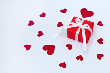 Gift box on the white background with red hearts. Women's Day, St. Valentine's Day, Happy Birthday and other holidays concept.