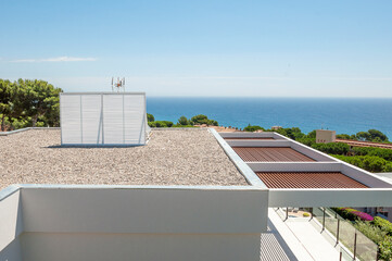  The roof of the house is covered with small stones. Crushed stone.