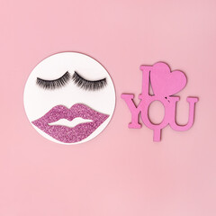 Creative woman face made of eyelashes and pink glitter lips and inscription I love you. Minimal concept, Valentine day card. Flat lay, top view.