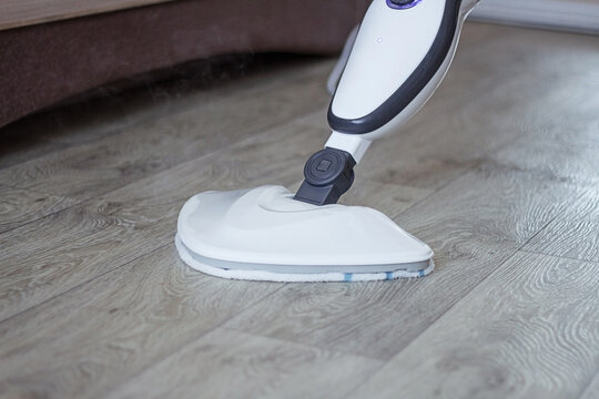 Cleaning the floor with a steam mop cleaner