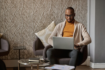 Black african entrepreneur working on laptop in coworking office space