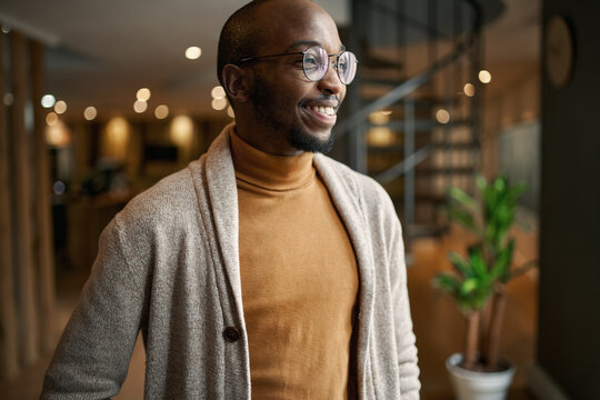 Portrait of creative trendy black african male designer smiling looking into distance