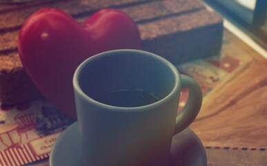 cup of coffee in the kitchen with a heart as a background