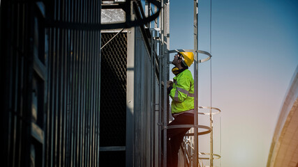 construction workers on a site. engineer under checking the industry cooling tower air conditioner...