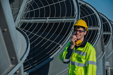 people using radio communication with smile on cooling tower background.