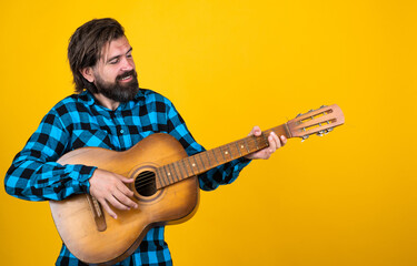 playing country music. trendy looking bearded hipster guitarist. music concept. brutal handsome man...