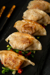 Japanese gedza dumplings. Asian food. Dark background.	