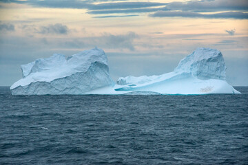 Floating Iceberg With A Colony Of Gentoo Penguins At Sunset In Bransfield Strait Near The Northern Tip Of The Antarctic Peninsula