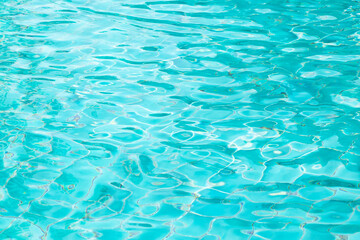 Ripple Water in swimming pool with blue tile floor background