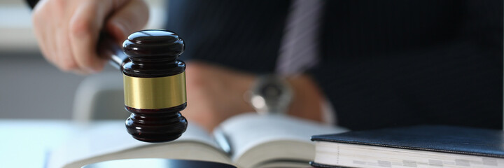 Competent attorney sitting at his workplace and announcing the decision after council of judges