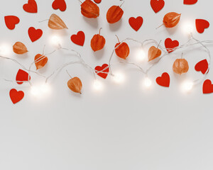 Valentine's Day background. Physalis flowers, wooden figures in the form of hearts and a luminous garland are on a gray background. Flat lay. Top view. Copy space.