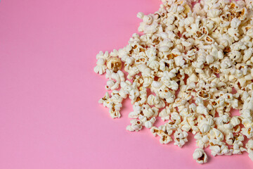 Popcorn on a pink background. There is a place for an inscription and a logo. Movie snack