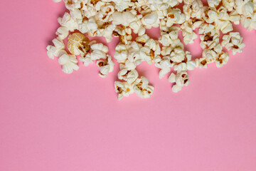 Popcorn on a pink background. There is a place for an inscription and a logo. Movie snack