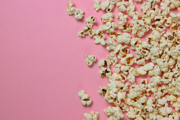 Obraz na płótnie Canvas Popcorn on a pink background. There is a place for an inscription and a logo. Movie snack