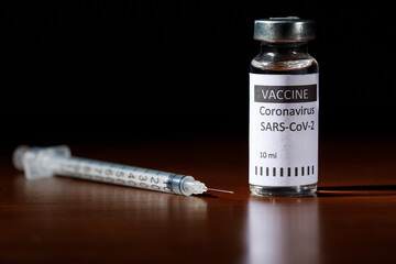 COVID-19 vaccine isolated on red wood background. Healthcare And Medical concept.