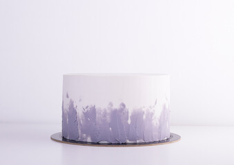 stylish white cake with gray gradient on a white table