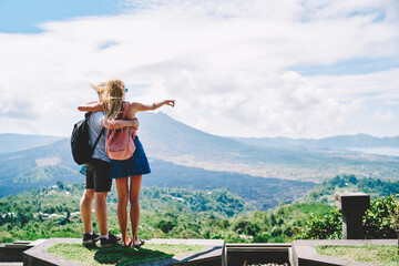 Faceless couple travelers enjoying picturesque and hugging