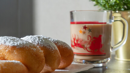Powdered sugar donuts with coffee. sunny morning breakfast