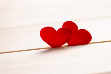 Close up of two red hearts on wooden table