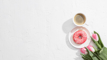 Obraz na płótnie Canvas March 8, International Women's Day. number eight, consisting of a cup of coffee and a donut with a pink filling, next to pink tulips on a white background. space for text
