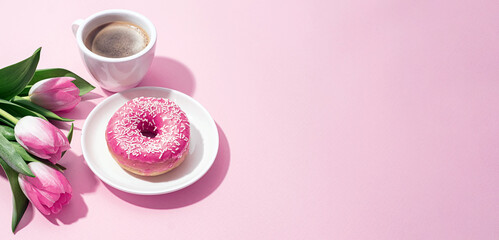 Obraz na płótnie Canvas March 8, International Women's Day. number eight, consisting of a cup of coffee and a donut with a pink filling, next to pink tulips on a pink background. space for text