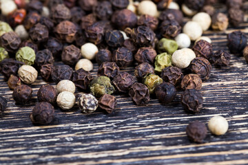 spice black pepper scattered on an old wooden table