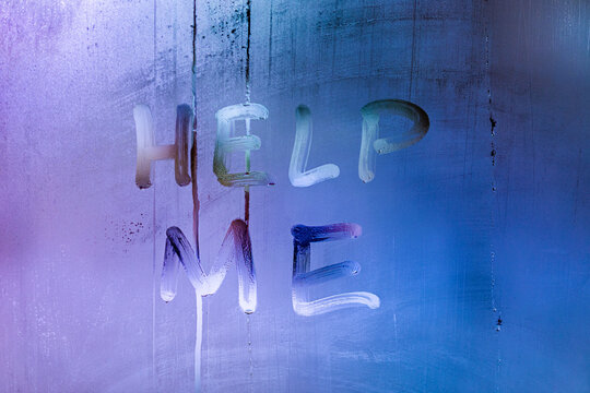 words help me handwritten on night wet window glass with blue color gradient