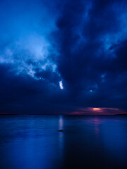Fototapeta na wymiar Night Seascape with Dramatic Blue Clouds over Martha's Vineyard