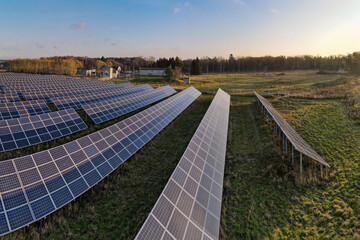 View to solar panels on field at sunny autumn morning from above
