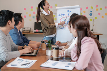 Portrait businesspeople standing by white board and giving presentation to colleagues during meeting in conference room. explaining something meeting to colleagues. Project results.