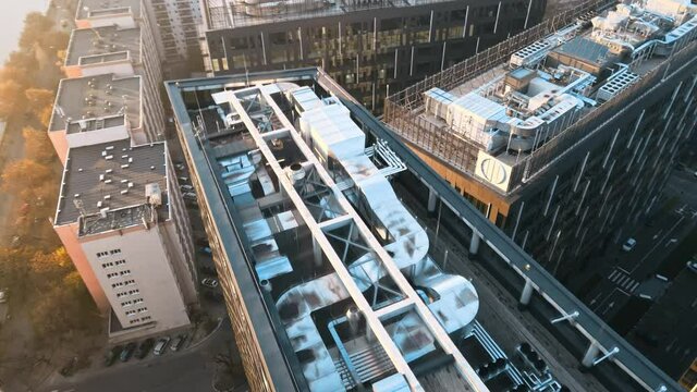 Roofs of high modern buildings and roads between them, water channel. View from the drone in Bucharest, Romania