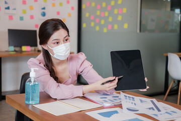 business worker meeting and brainstorm for startup new business. man and woman wear protective face mask in new normal office preventing coronavirus COVID-19 spreading. New normal business concept.