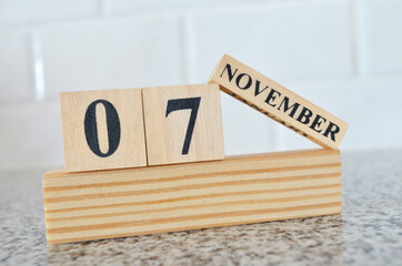 November 7, Cover design with number cube on a white background and granite table.