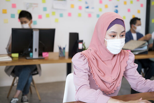 Saudi Arab Woman Work In Socially Spaced Offices. Social Distance Wear A Mask Prevent Spread From Coronavirus. Work Like A Professional.