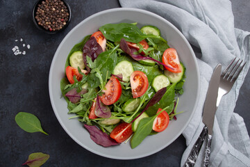 Healthy fresh salad of vegetable cucumber, tomato, spinach, arugula