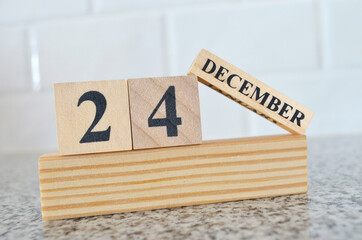 December 24, Cover design with number cube on a white background and granite table.