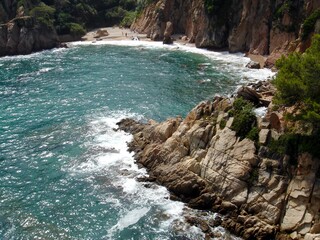 View of a stone bay from a cliff, in the Spanish city of Blanes.