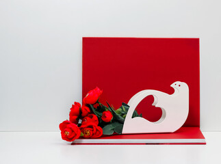 white doves with heart symbol on red book and flowers background