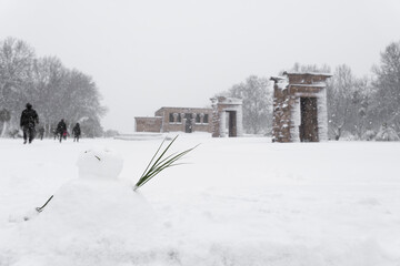 A little snowman is sitting in front of Temple of Debod covered in snow during the Madrid historic snowfall and coronavirus pandemic