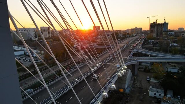 Ciurel passage, bridge over a river with moving cars. Residential buildings on the background. View from the drone. Bucharest, Romania