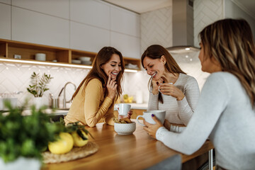 Three adult woman discussing at home.