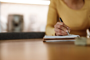 Fototapeta premium Holding pen, writing something, home office.