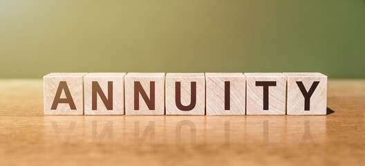 ANNUITY word written on wooden blocks on wooden table. Concept for your design. - obrazy, fototapety, plakaty