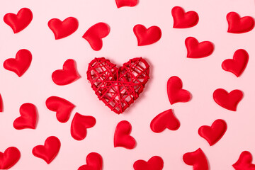 Red hearts on a pink background. Minimalistic concept for valentine's day. Place for your text.